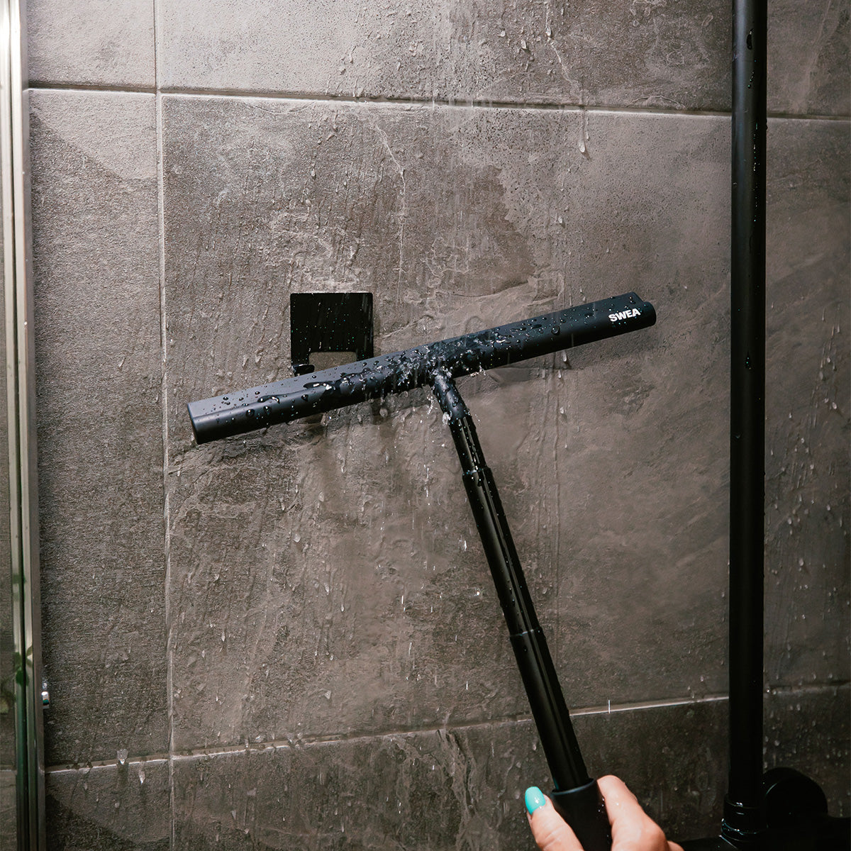 A person using the wet SWEA shower squeegee 